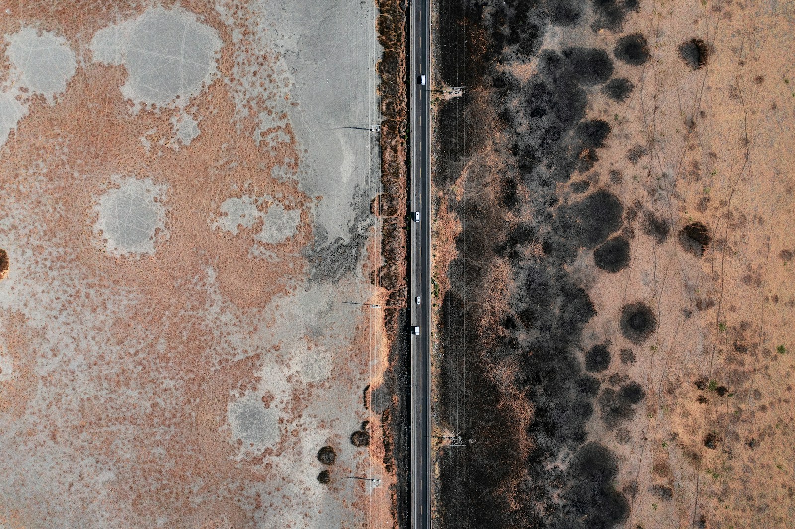 an aerial view of a road and a field